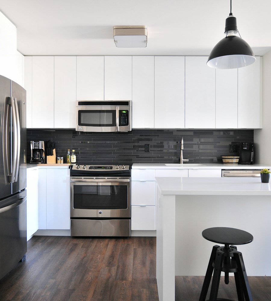 Stainless steel built-in refrigerator and range in a modern kitchen